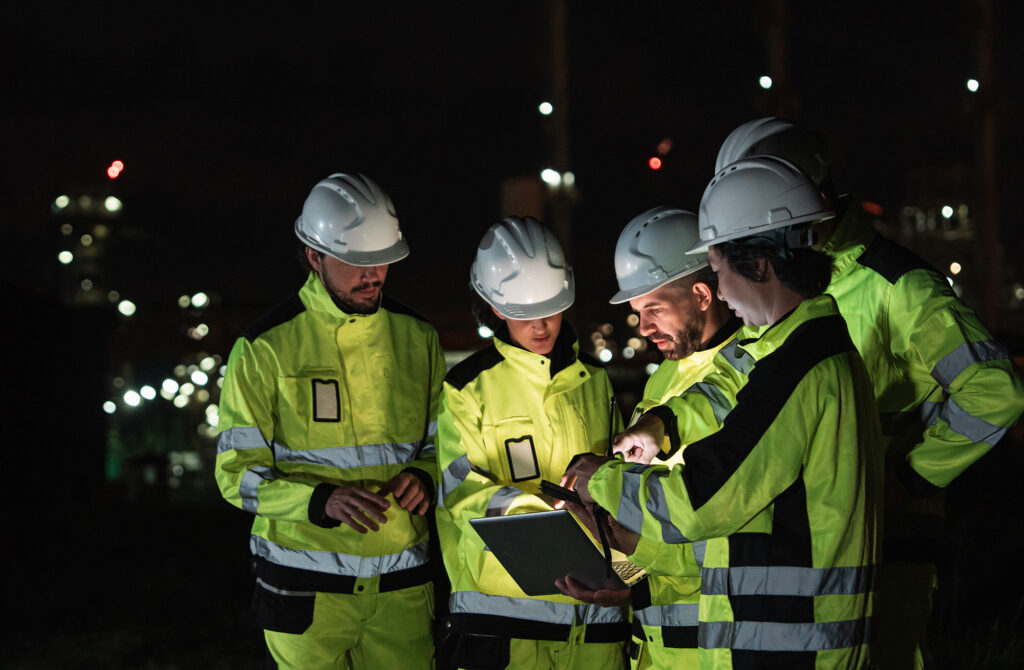 Are we collecting data or are we learning? Workers look over plans together.