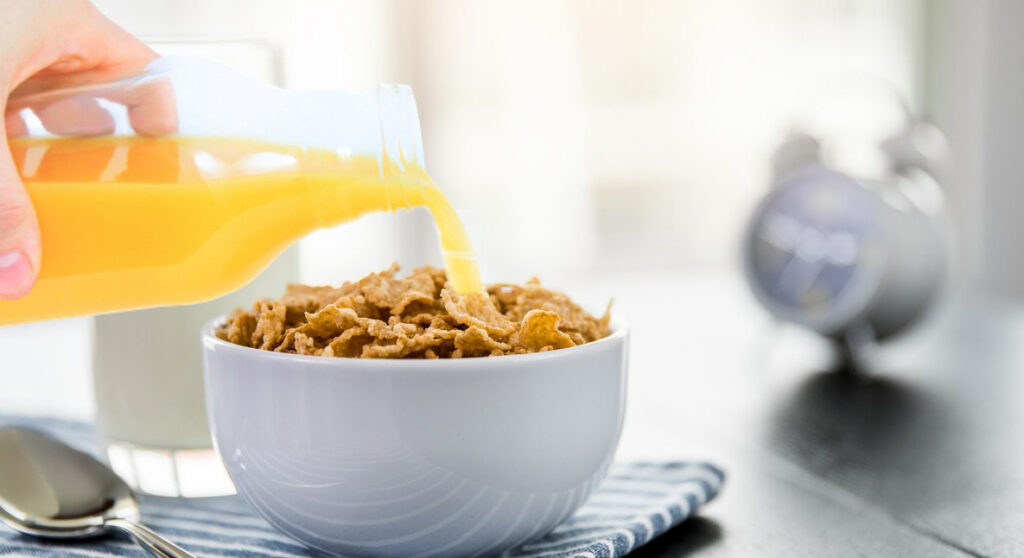 Beyond "root cause: human error". Error is normal - a person pursues orange juice on their cornflakes.